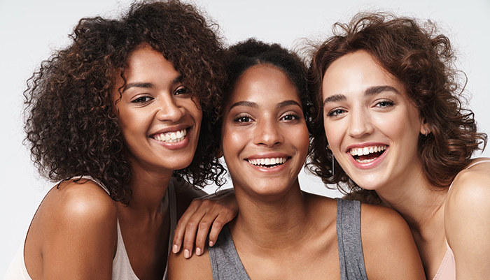 Three young smiling women